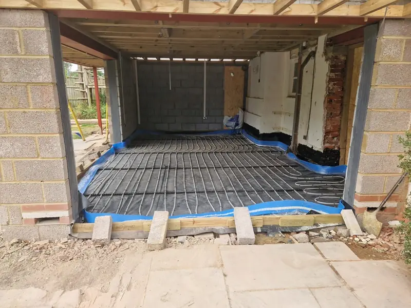 Underfloor heating pipes laid across insulation inside the new extension, ready for the screed