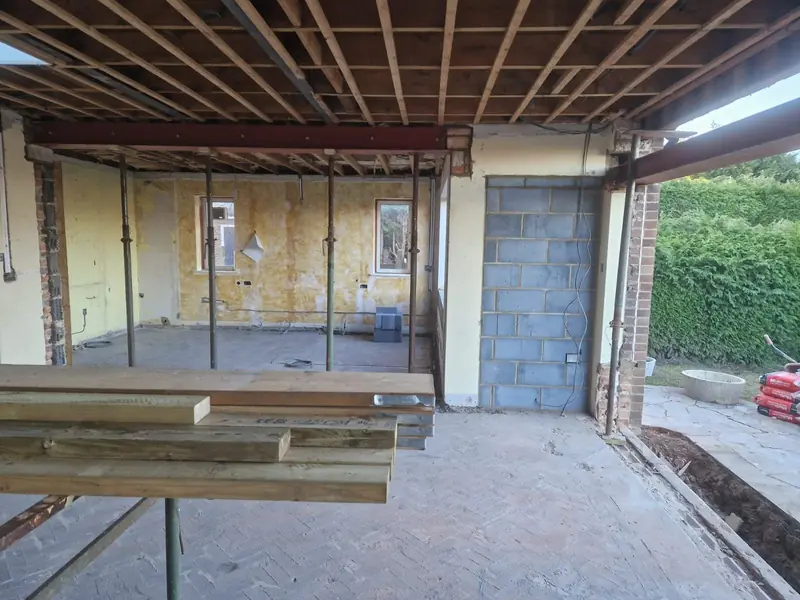 Steel beams spanning a newly opened room, with the props still in place
